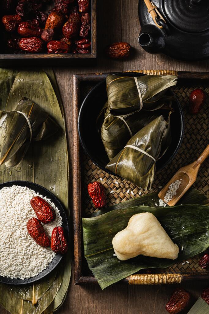 Zongzi is one of the delecacies that people eat during the Dragon Boat Festival. The image shows the ingredients and the cooked Zongzi.