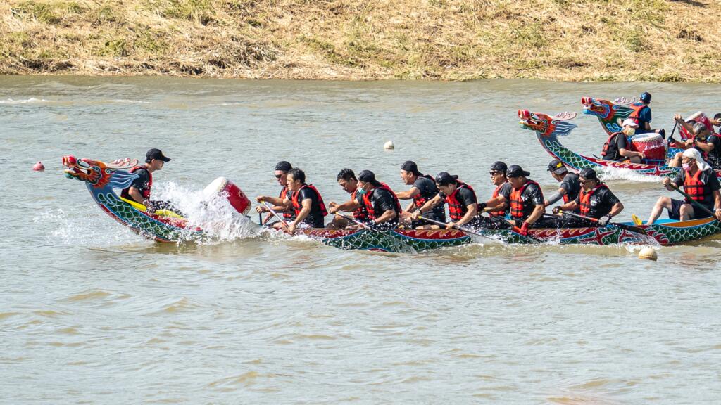 The image shows dragon boat competition during the dragon boat festival